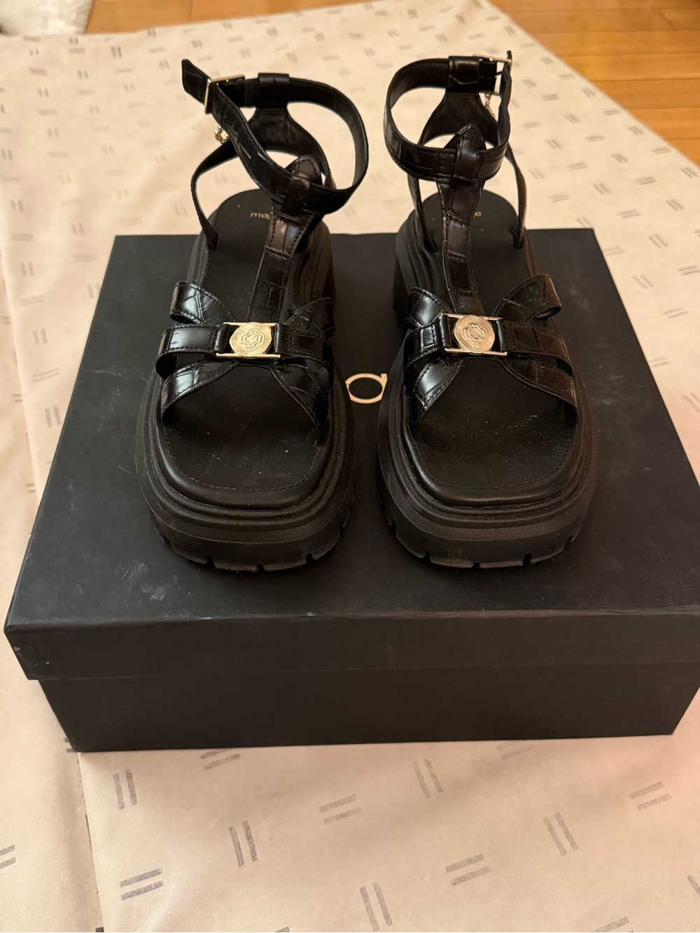 Maje Black Platform Ankle-Strap Sandals with Gold Medallion